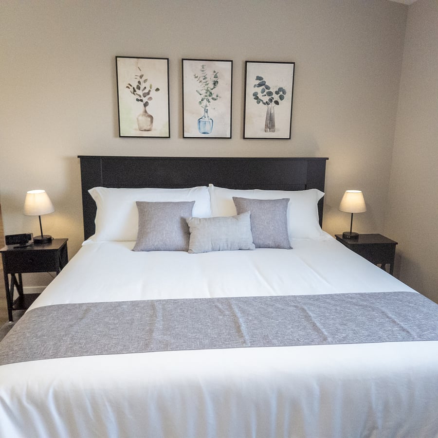 This spacious main bedroom with a king-size bed has a calming color scheme. It also has a walk-in closet and a 55" smart TV. This bedroom has a tranquil oasis for relaxation and a perfect escape from the day's hustle and bustle.