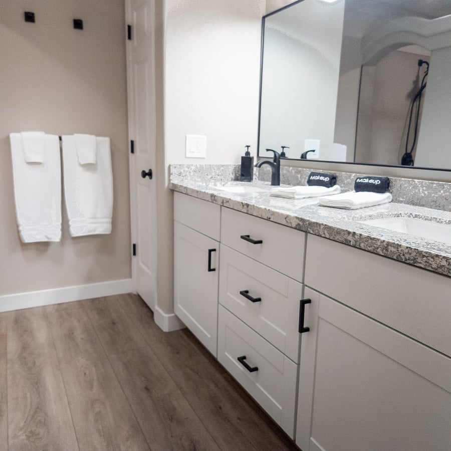 The ensuite main bathroom has ample counter space for getting ready for the day and drawers and cabinets for storing toiletries and other essentials.