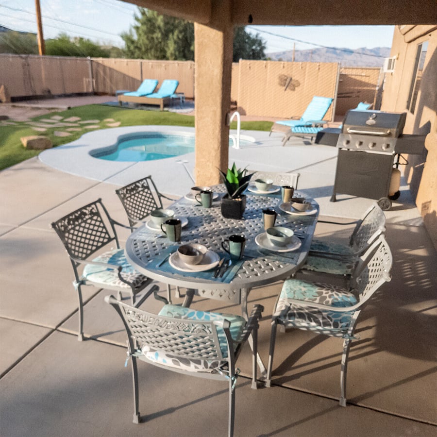 Embrace the morning and savor the peacefulness of the backyard oasis with a cup of coffee under the covered patio. It's a refreshing start to a new day.