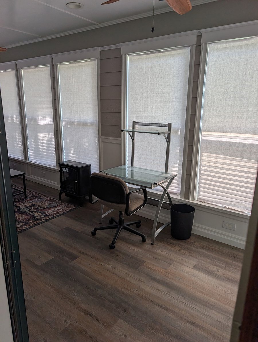 Private space, Unit #1: The front sunroom is a nice spot to sit and relax, or to use as an office. There is a computer desk in both the bedroom and the sunroom.