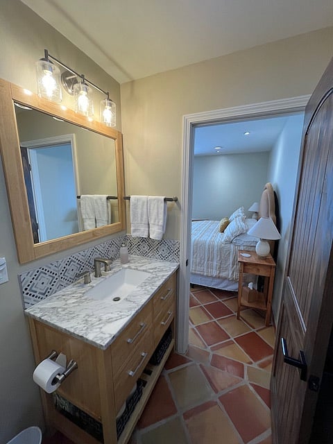 Primary ensuite bathroom with marble tiled walk-in shower