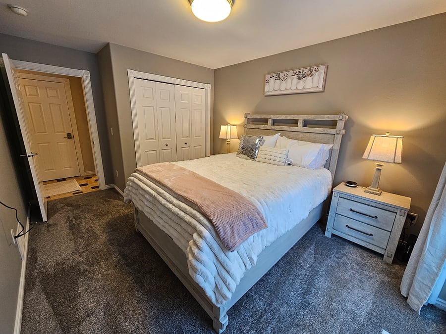 Peaceful queen room with sliding door to backyard