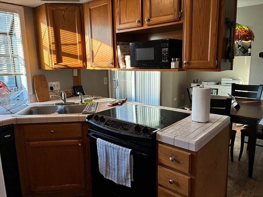 Kitchen with electric range and microwave.