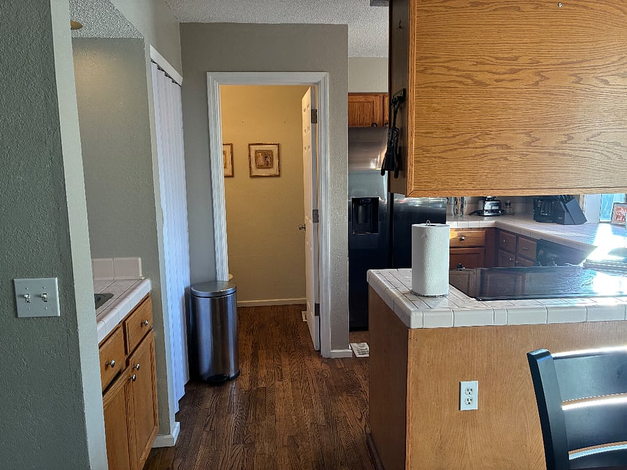 View of half bath off kitchen (shared) from dining area