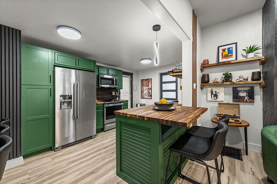 Gather in a kitchen that blends modern style with charm modern cabinetry, sleek appliances, and a rich wood island perfect for morning coffee, shared meals, or catching up on work. Thoughtful dcor creates a space as inviting as it is functional.