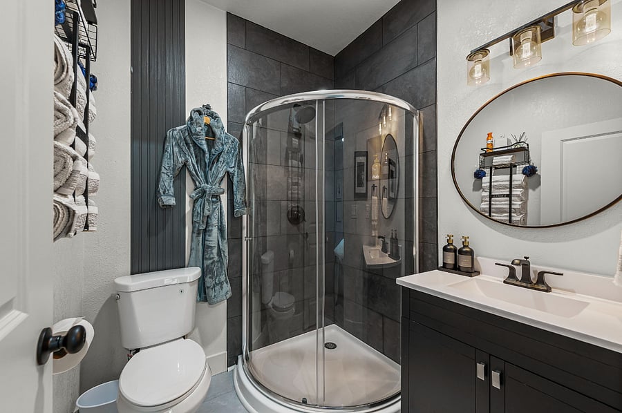 Step into the ensuite bath featuring a sleek walk-in shower, luxe robes, and spa-inspired details. Fresh towels, quality toiletries, and modern finishes make this a refreshing start or end to your day.
