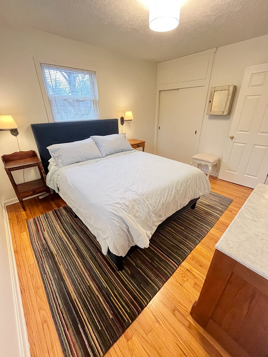 queen bed bedroom with privacy blinds