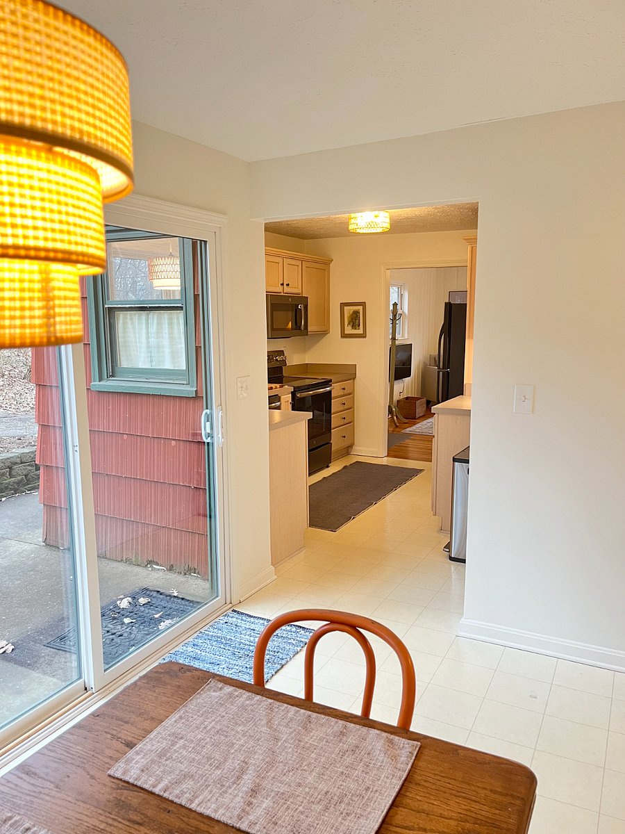 view from dining room (with sliding door to patio) back through kitchen and into living room