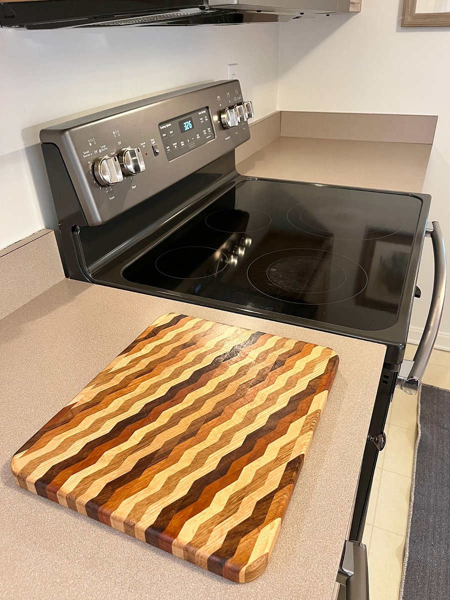 full sized range and beautiful wooden cutting board