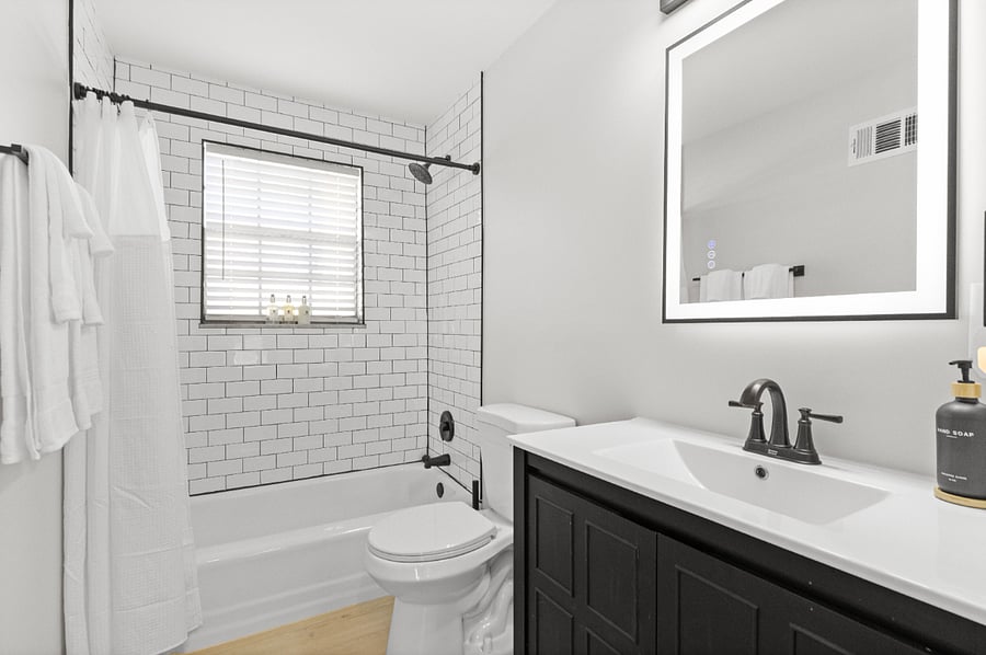 Refinished bathroom with new fixtures and anti-fog mirror that is self lit