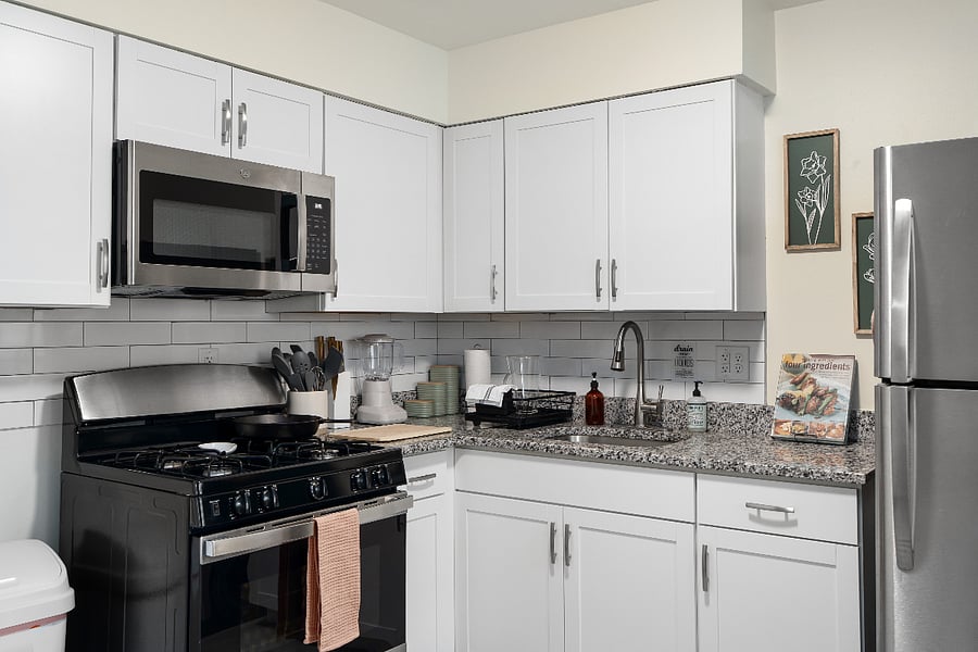Well-equipped kitchen with full-size appliances, cookware, dishes, blender, and coffee setupready for home-cooked meals.