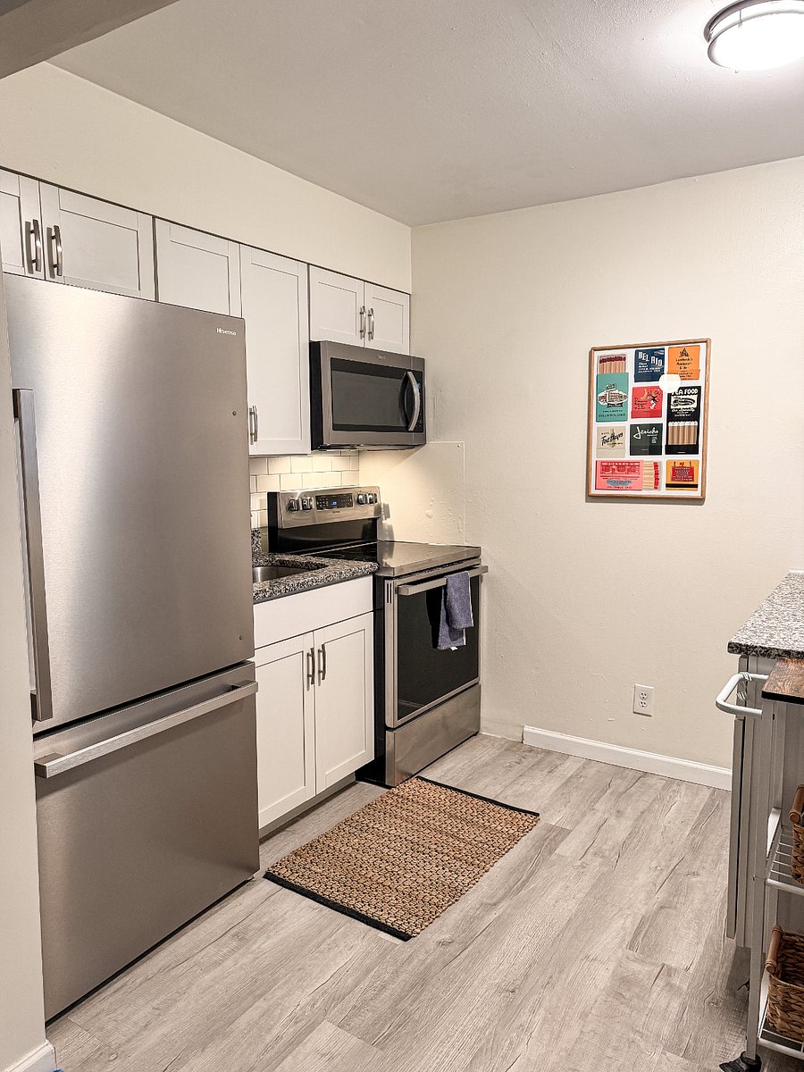 Full kitchen with refrigerator, stove, microwave, and all essential cooking supplies included. Please note: no dishwasher.