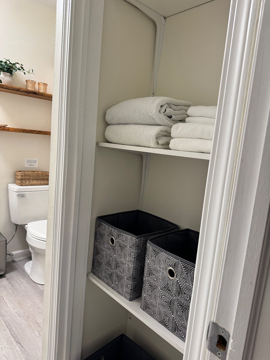 Linen closet near the bathroom with space for toiletries and personal items.