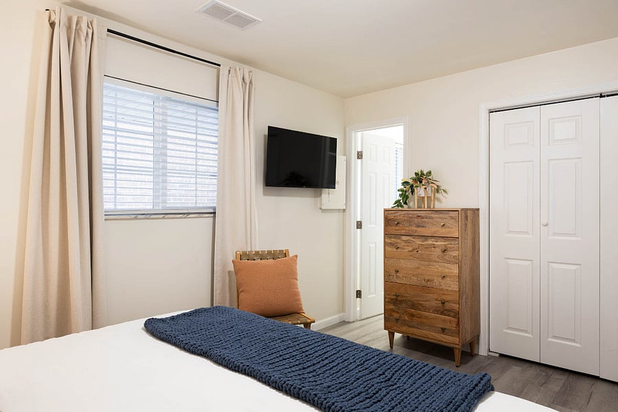 Bedroom features a smart TV that can be angled for easy, comfortable viewing from bed