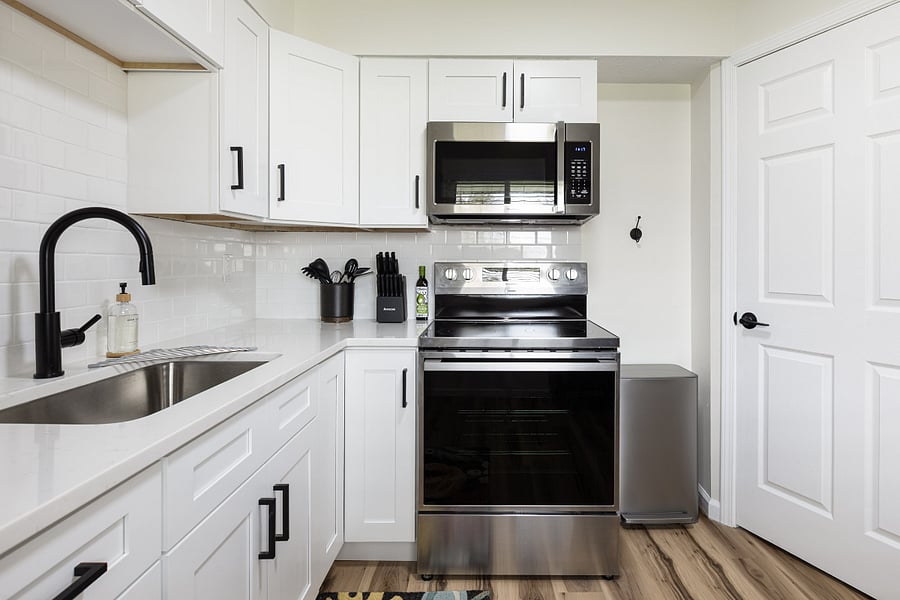 Fully stocked kitchen with brand new appliances and cooking essentials.