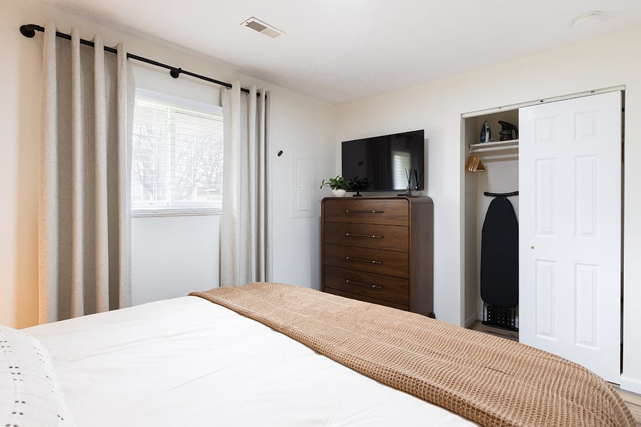 Bedroom with closet storage and Smart TV for added comfort.