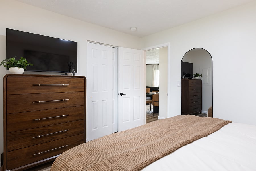 Primary bedroom featuring a Smart TV and cozy, hotel-style bedding.