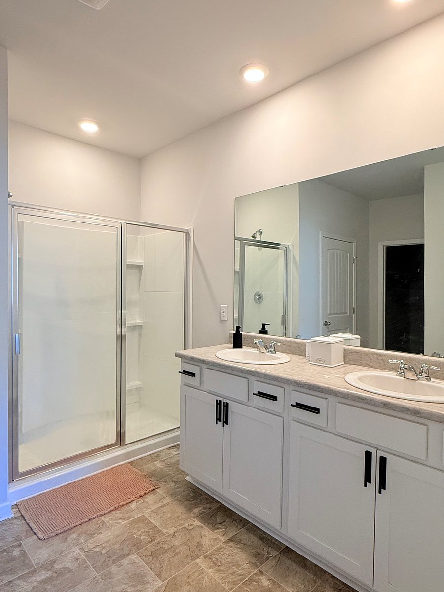 Primary Bathroom with Double Vanities and Walk-in Shower