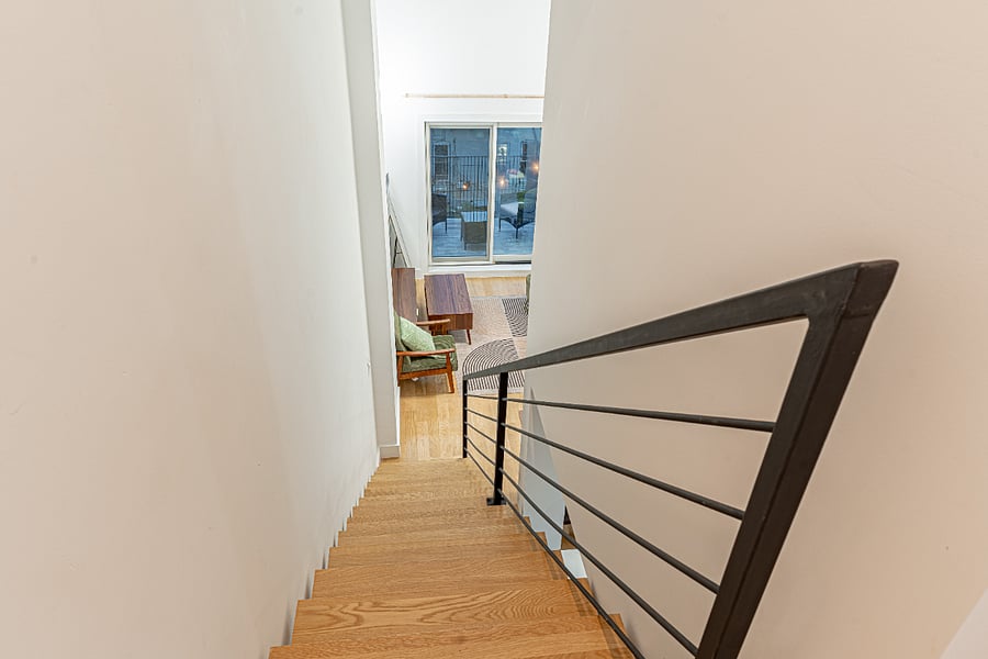 Stair/loft walkway viewunique two-level layout that makes the space feel like a true penthouse retreat.