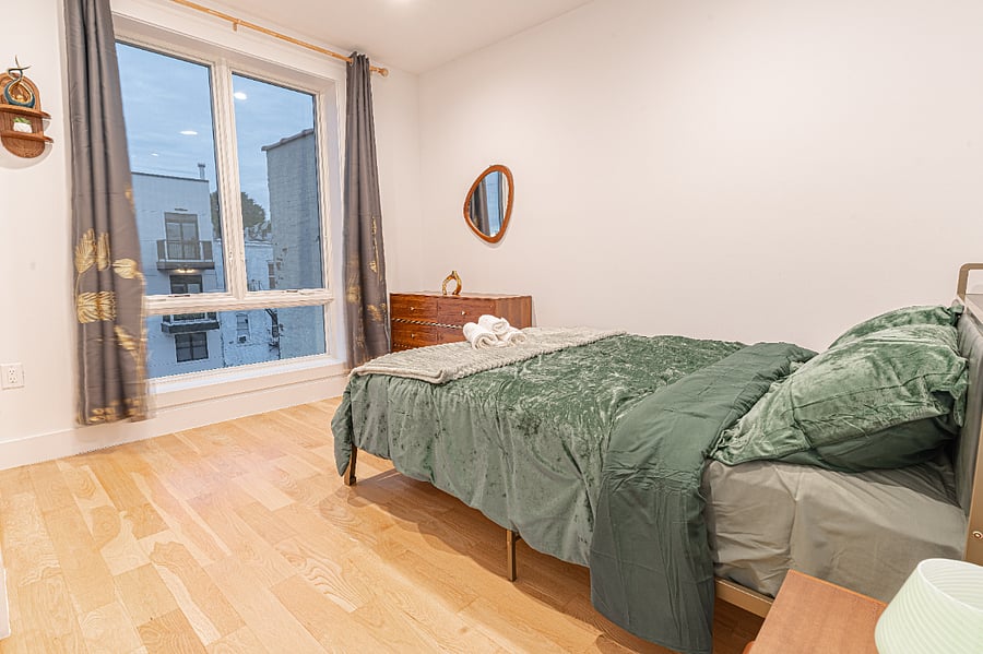 Bedroom angle with window lightquiet, bright, and designed for comfort during extended stays.