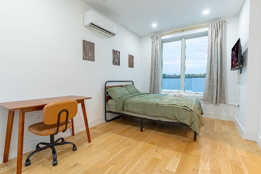 Bedroom + desk + skyline lighta calm setup for sleep and productivity in one.
