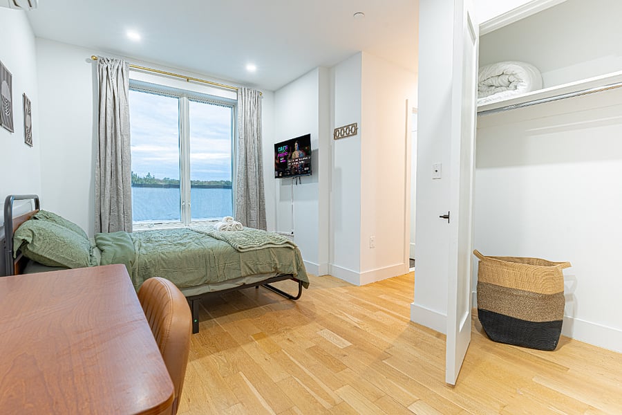 Bedroom + desk + skyline lighta calm setup for sleep and productivity in one.