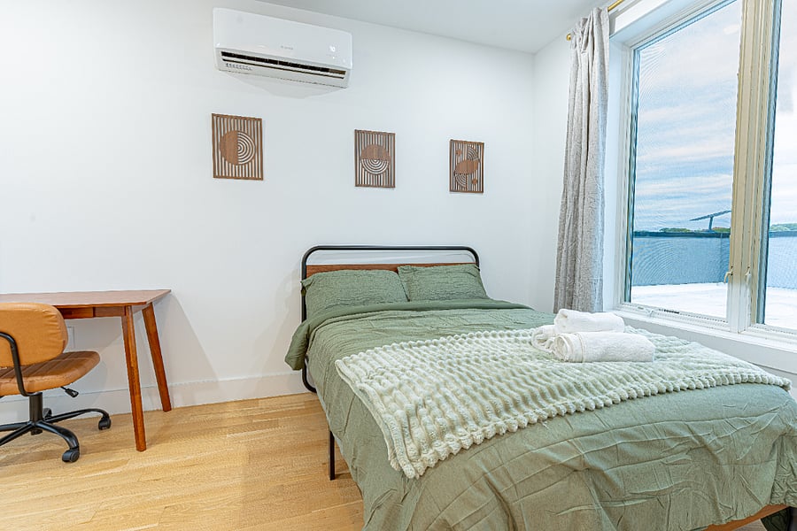 Bedroom + workspace by the windownatural light + comfort for longer bookings.