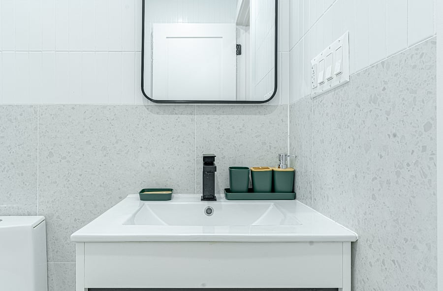 Contemporary vanity and sink with storage and mirrorfunctional and well-lit for daily use.