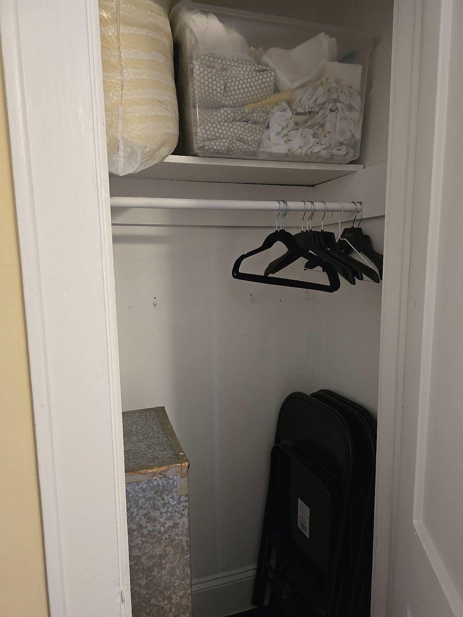 2nd bedroom - second closet with chairs and extra linens/ bed sheets