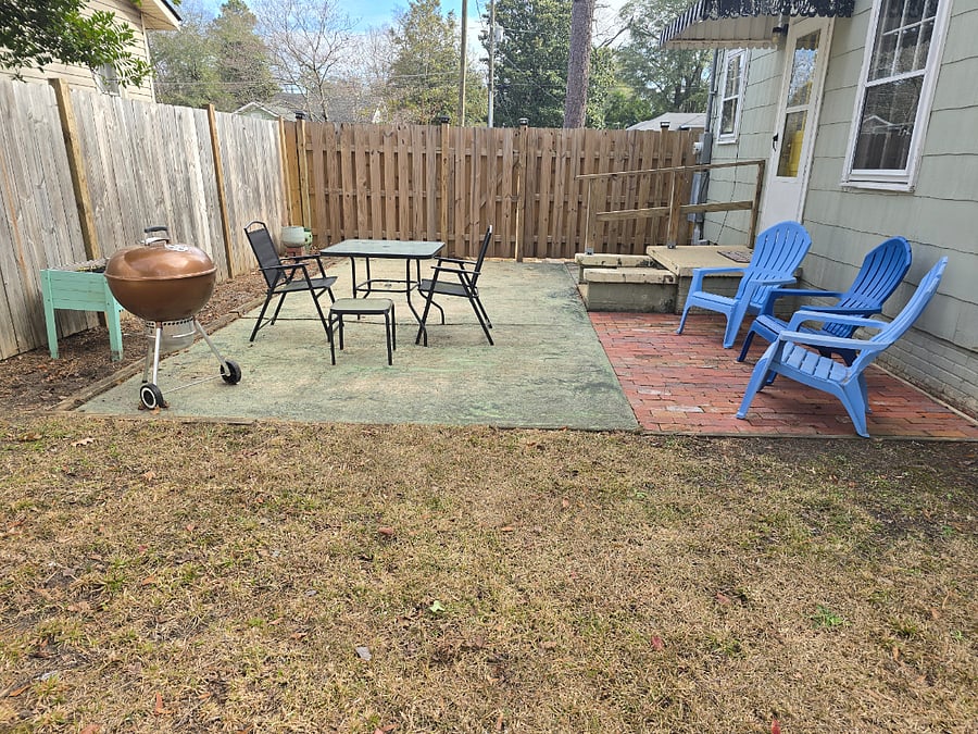 Back patio with chairs, table, and Weber charcoal grill