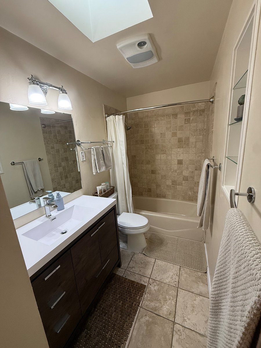 Hallway bathroom with bathtub