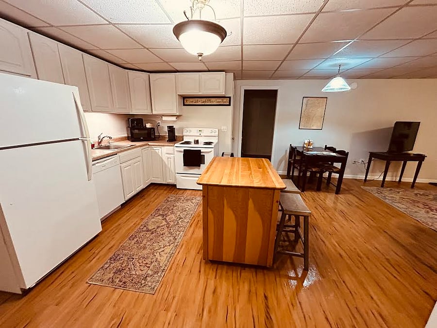 Find everything you need to cook or bake in this open concept kitchen with a full size fridge, dish washer, electric stove and plenty of cupboard space.