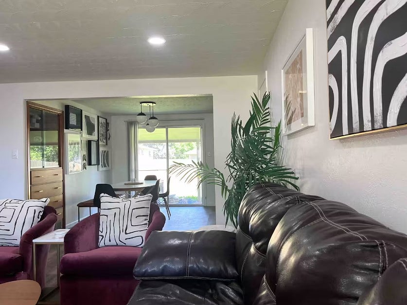 large living room w excellent natural light open to dining room (couch has been upgraded to electric reclining in light gray color)