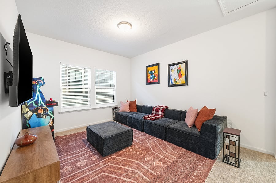 Upstairs loft area with 65" Smart TV and Arcade