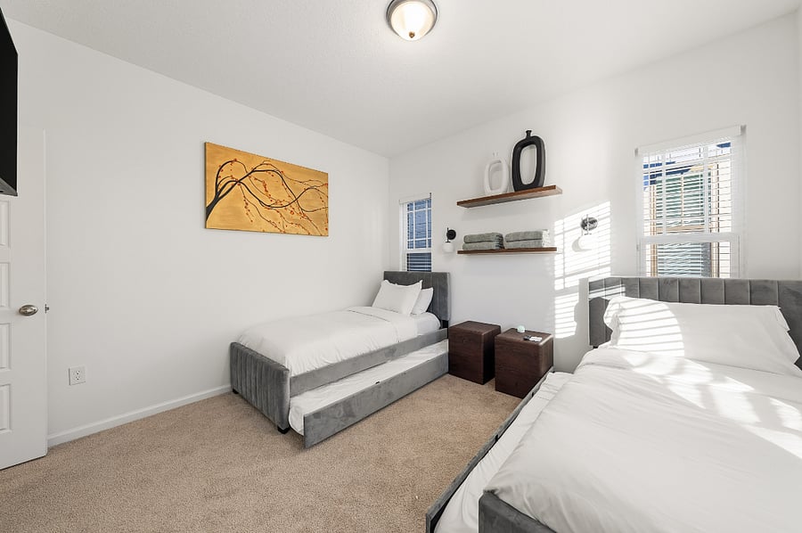 Guest Bedroom #2 with two twin trundle beds with 43" Smart TV in room. 