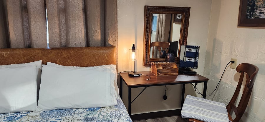This area can be used as a Desk or Make Up Table. There is a Hot Iron/Curler Holder with a Hair Dryer ready to use. The mirror to the right is Magnified and Lights Up.
