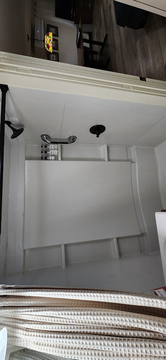 Enjoy our large shower with Shampoo, Conditioner and Body Wash. There is also a grab bar for safety and shelves for your personal items.