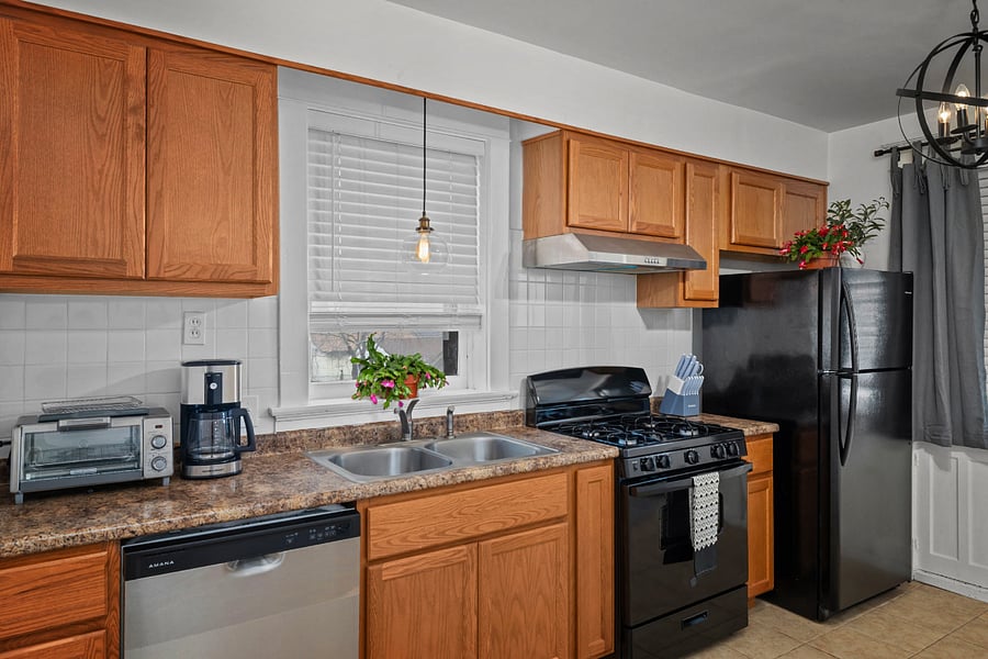 Fully equipped kitchen with gas stove, dishwasher, and ample cabinet space well suited for everyday cooking.
