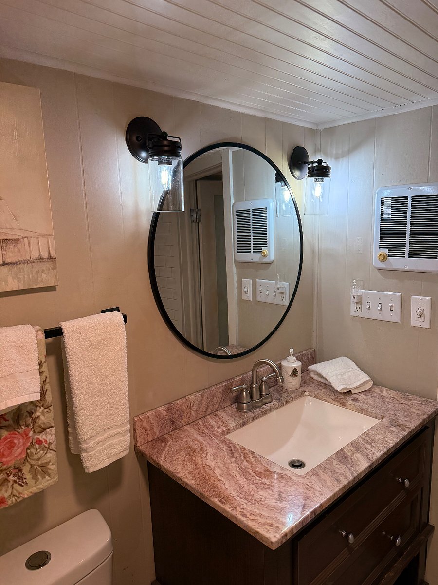 Upstairs full bathroom. Features a wall heater on a timer.