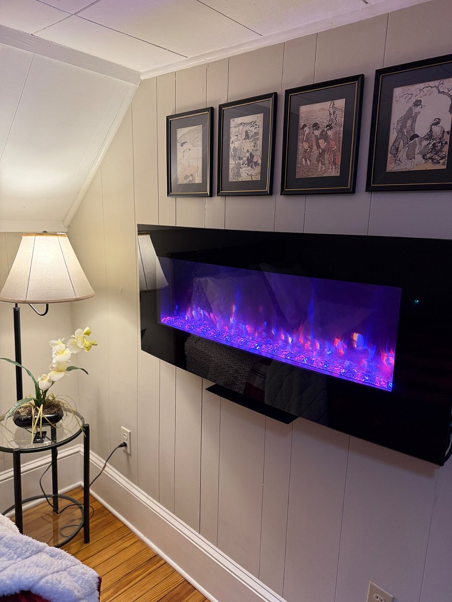Electric Fireplace in upstairs bedroom. Includes a bedside remote control.