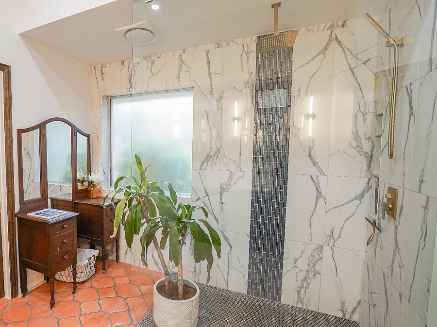 A spacious walk-in closet leads to the spa-inspired en-suite bath: glass-walled rainfall shower, dark mocha colored vintage vanity with pearly white double sinks and wall-mounted matt gold faucets, separate water closet for privacy all secured by smart keyless entry.