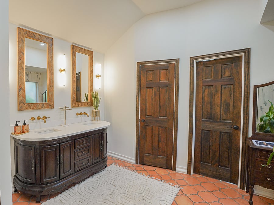 A spacious walk-in closet leads to the spa-inspired en-suite bath: glass-walled rainfall shower, dark mocha colored vintage vanity with pearly white double sinks and wall-mounted matt gold faucets, separate water closet for privacy all secured by smart keyless entry.