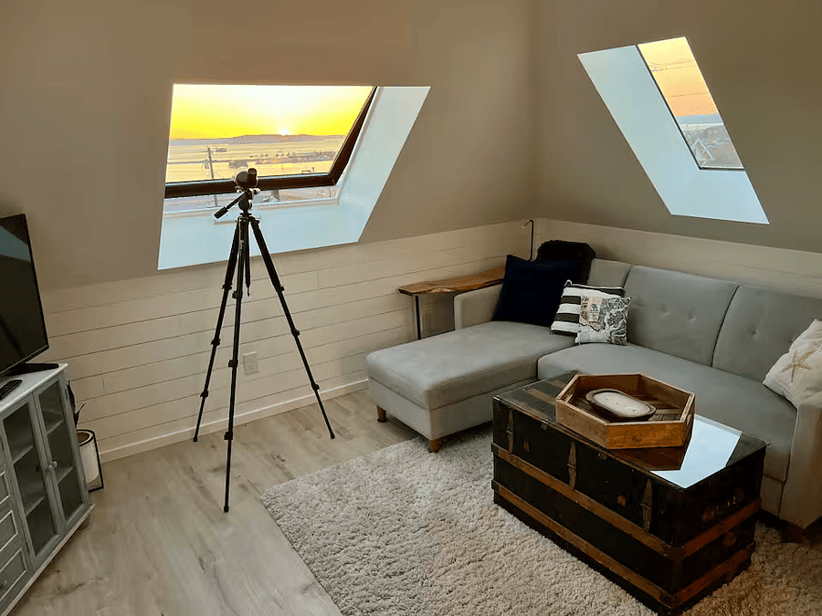 Attic Living Room with Smart TV, VSeeBox, and Storage.