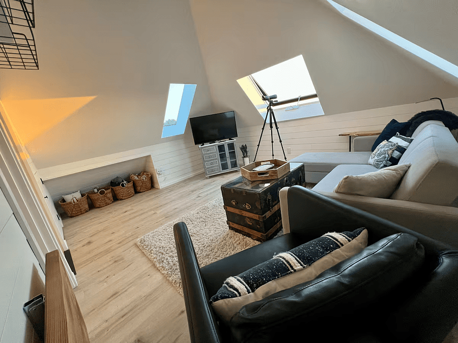 Attic Living Room with Smart TV, VSeeBox, and Storage.