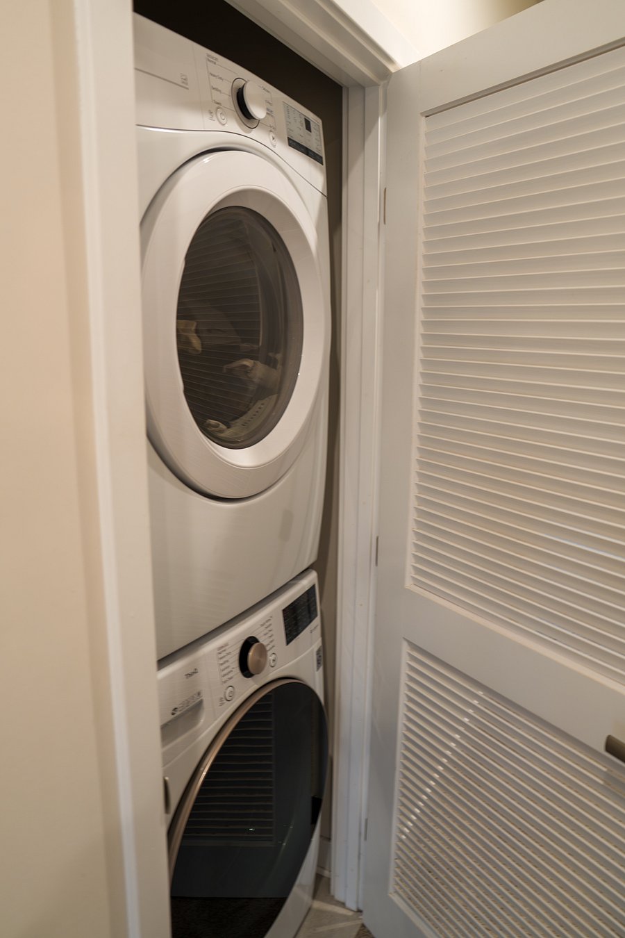 Stacked Washer and Dryer on Primary Bedroom Floor