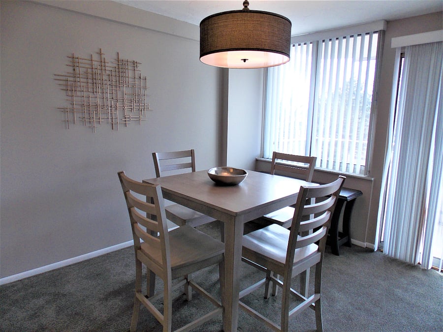 Sunny and bright dining area with 4 top table.