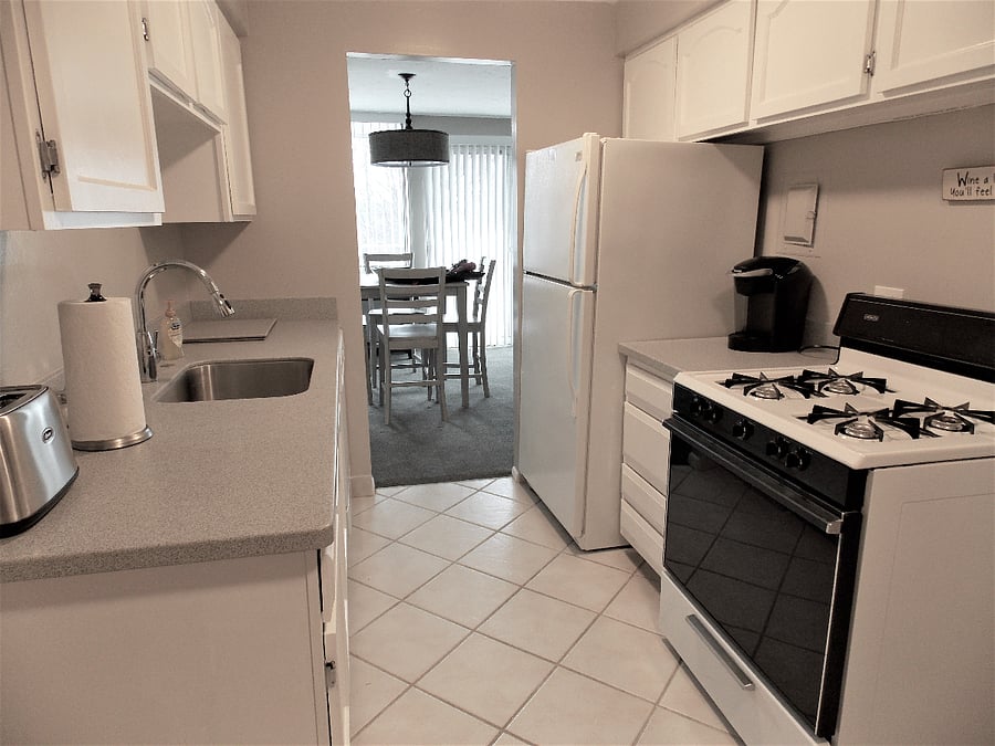 This is an older photo with the old stove. But shows the view from one end to the other. Also shows full sized refrigerator/freezer.
