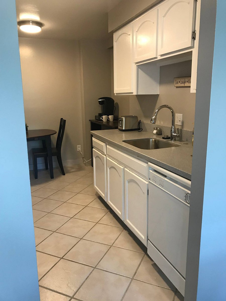 View of Coffee Bar on an extra storage cabinet. Sink area and dishwasher.