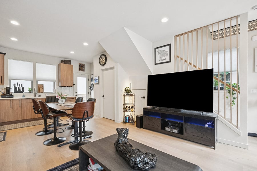 Living Room-Open Concept 75" Fire TV. Dining room table is a 6 person table that doubles as bar or cocktail height with adjustable chairs