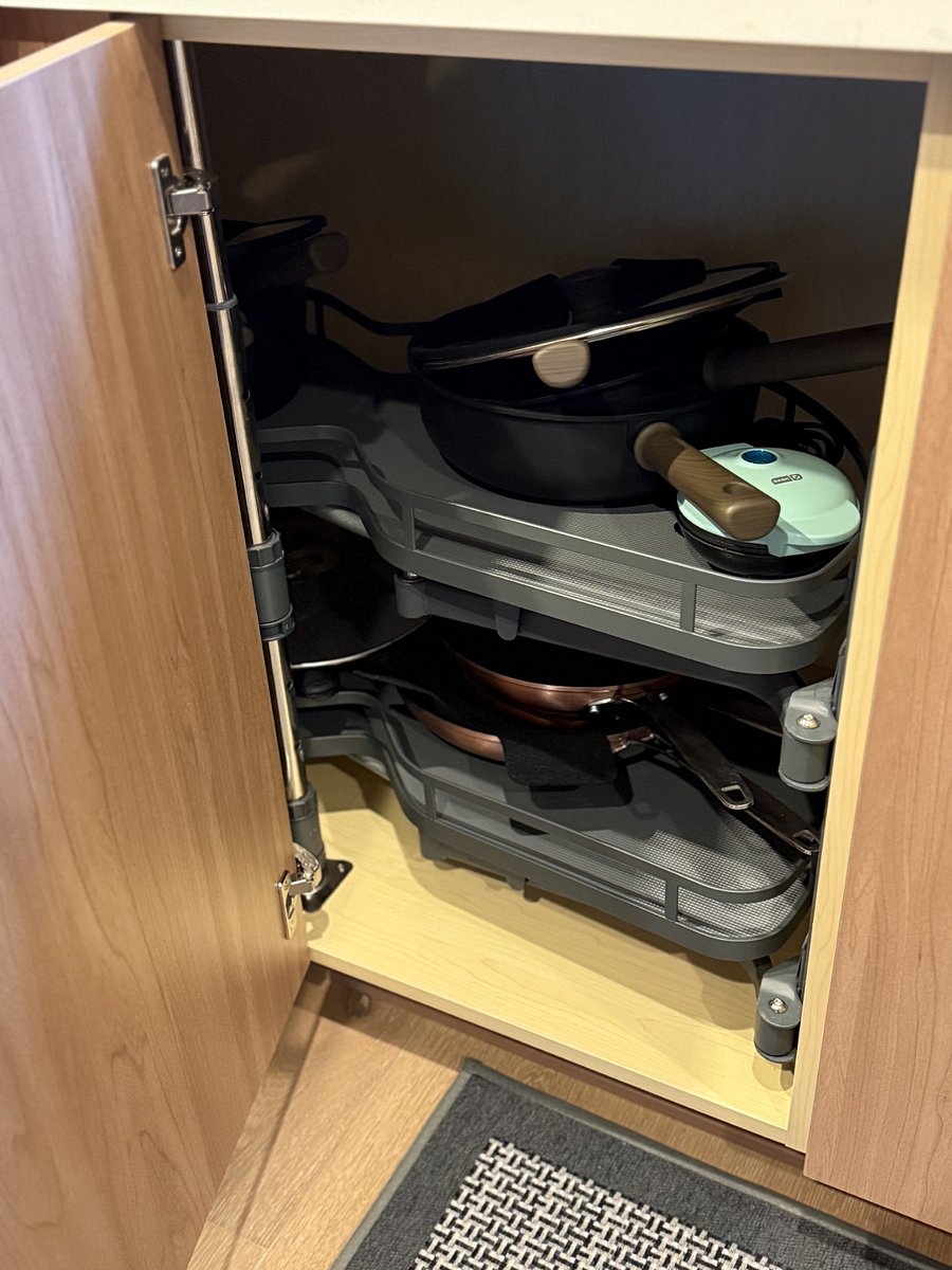 very functional lazy Susan with high end skillets, cast iron and pots and pans